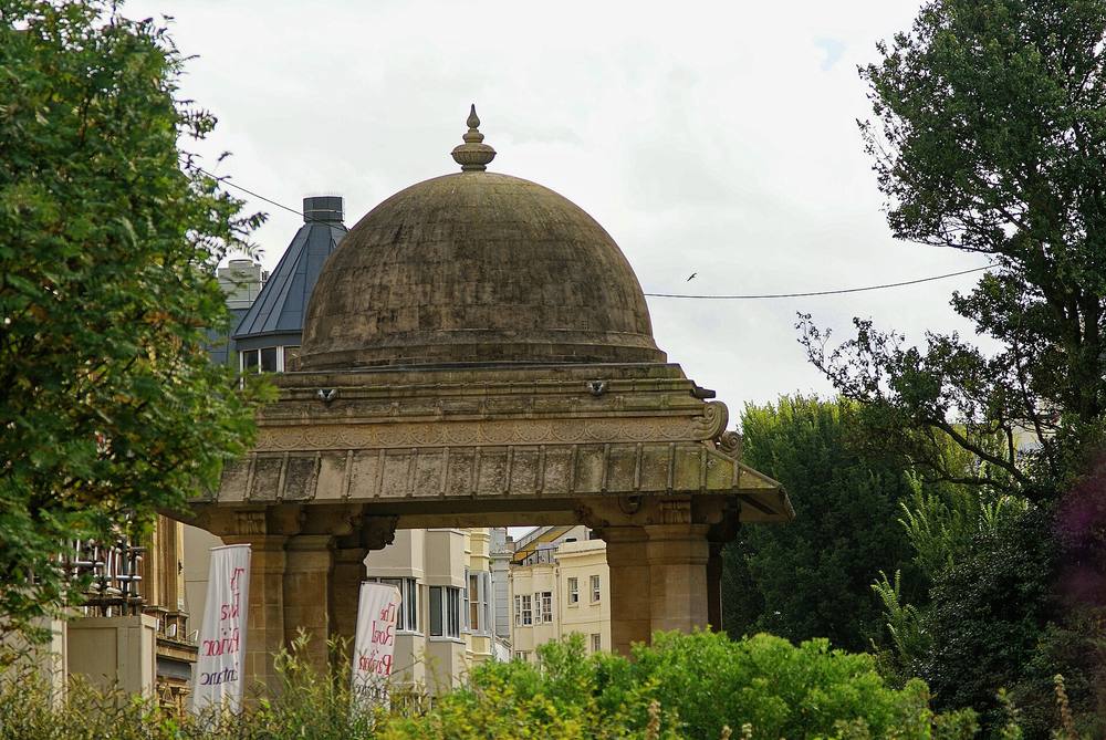 The domed Indian Gate in Brighton seen between trees with buildings behind it