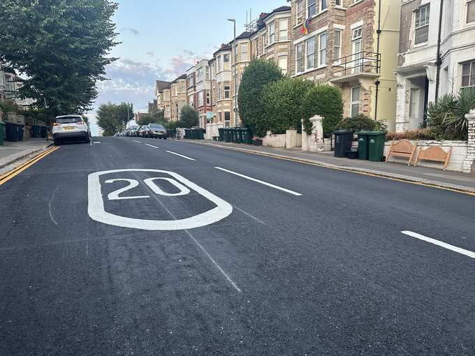A freshly resurfaced residential street in Brighton and Hove with a new 20mph marking and terraced houses
