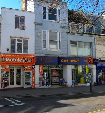 The Card Factory shopfront on Western Road in Brighton, with flats and offices above