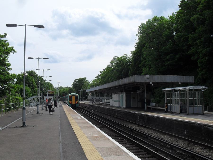A Southern train approaching Preston Park station in Brighton, seen from the platform
