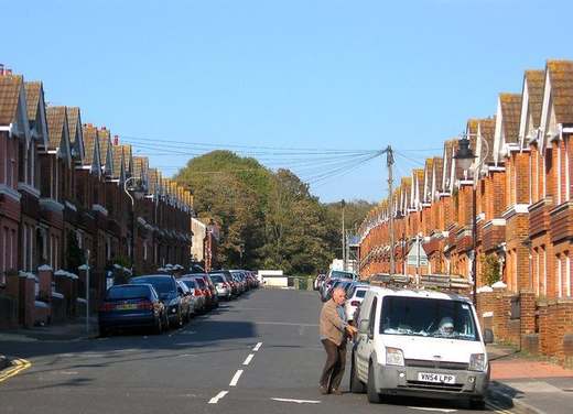 Terraced houses on Tillstone Street in Brighton, with a van parked in the road