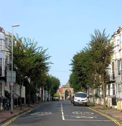 Egremont Place in Brighton, a street of tall terraced houses leading to the gateway of Queen's Park