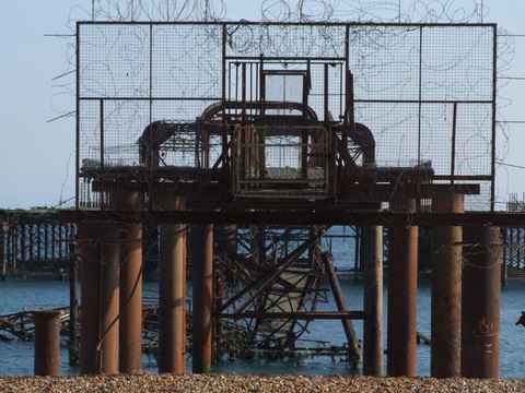 Rusty barbed wire barrier structure on the pier remains