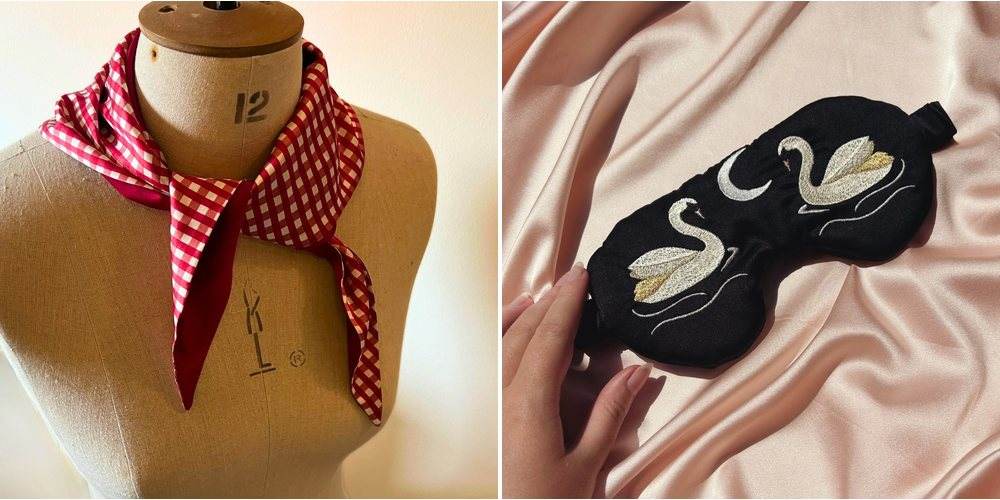 A burgundy and gingham silk scarf on a dressmaker’s mannequin, next to a black silk eye mask embroidered with two swans and a crescent moon