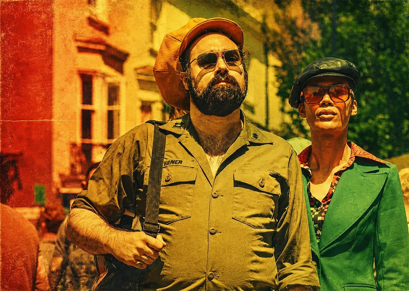 Frankie Dread and Tara Gold of The Tribulizations in colourful outfits on a Brighton street, photographed by Gilly Photography