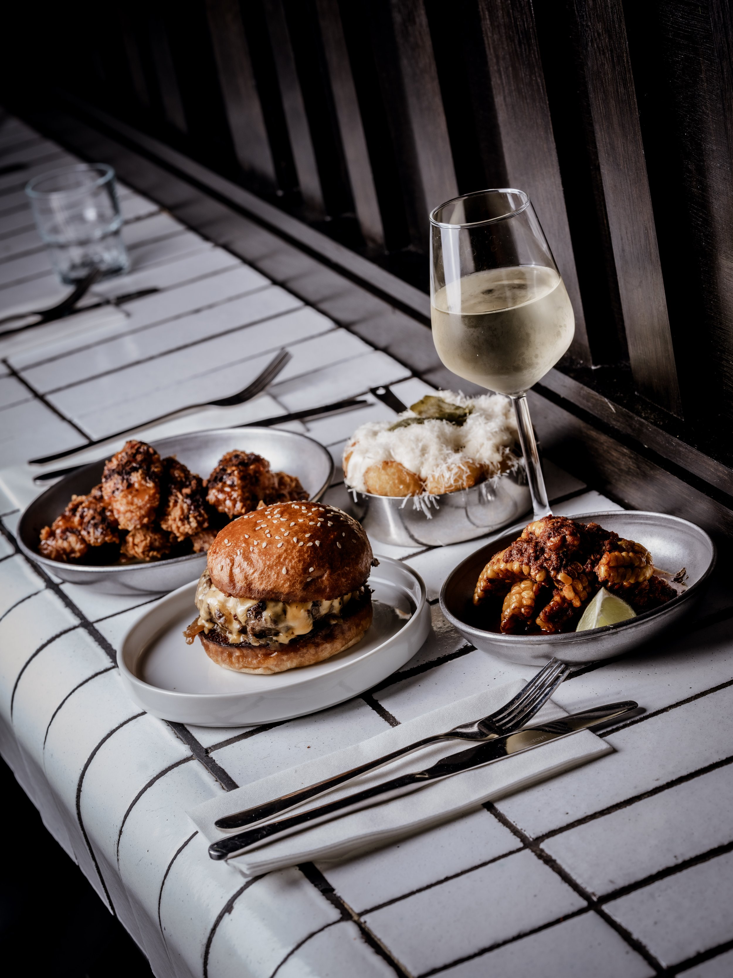 Burger & Beyond meal served with sides and drinks at the Brighton restaurant. Photo: Burger & Beyond
